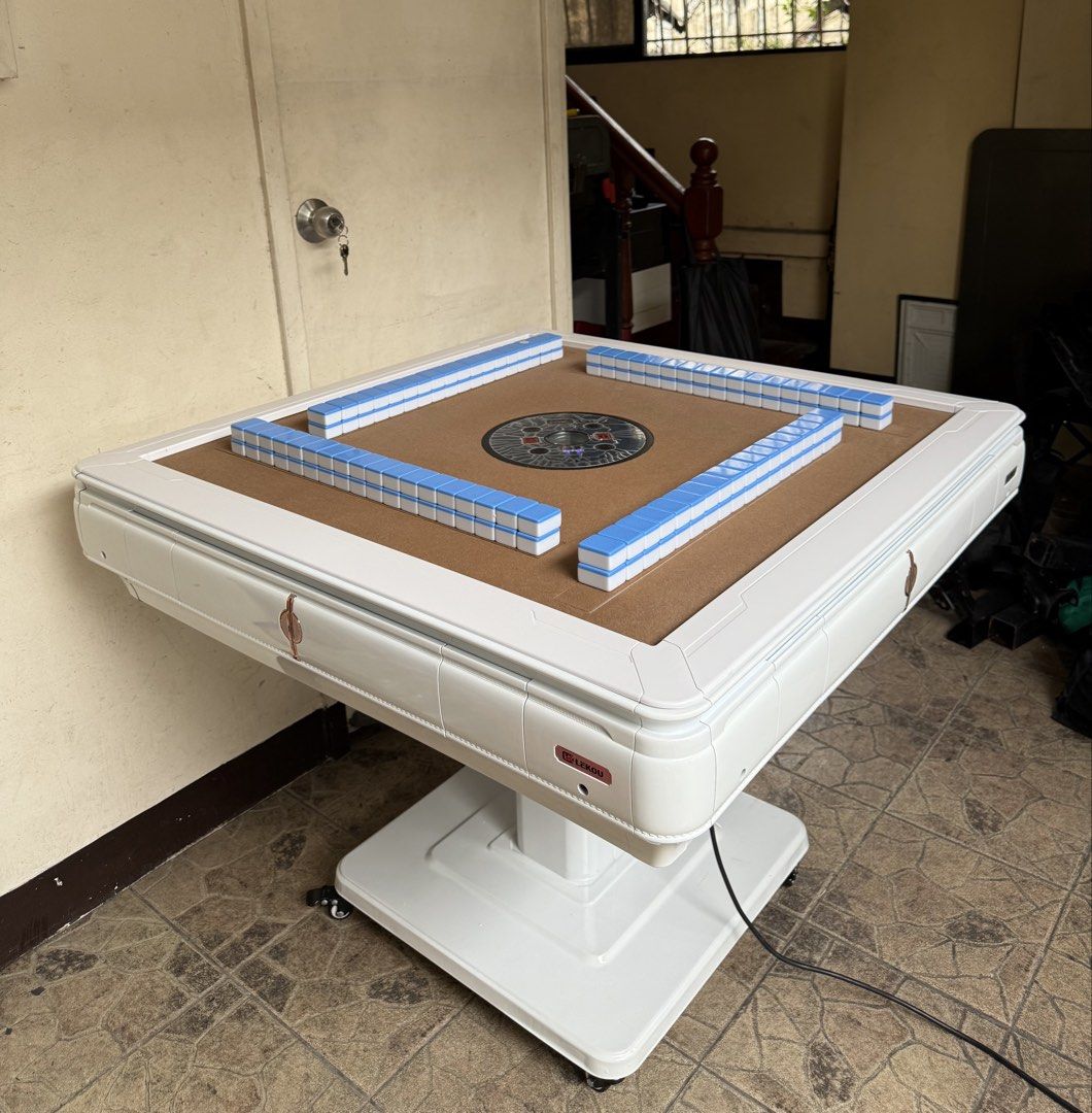 Brand new automatic mahjong table complete set (Category: Tables & Sets) located in Mandaluyong City. Submitted by jenerously (Listing ID 1458669929, Image 3). Description: •Brand new foldable table. •With 2 colors of magnetic tiles 144 •Complete compartments (ashtray, cup holder, money/ mobile phone holder and USB connector. *With wooden cover •Mandaluyong near mrt boni location. •Pick up or COD .