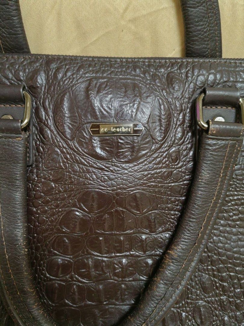 Brown Crocodile Embossed Leather Laptop Bag (Category: Laptop Bags & Sleeves) located in Manila. Submitted by junejanuary (Listing ID 1458500212, Image 3). Description: - Dark brown leather laptop bag - Crocodile embossed texture - Sturdy top handles - Detachable shoulder strap - Zip-top main compartment - Ample space for laptop and work essentials - Classic and professional design.