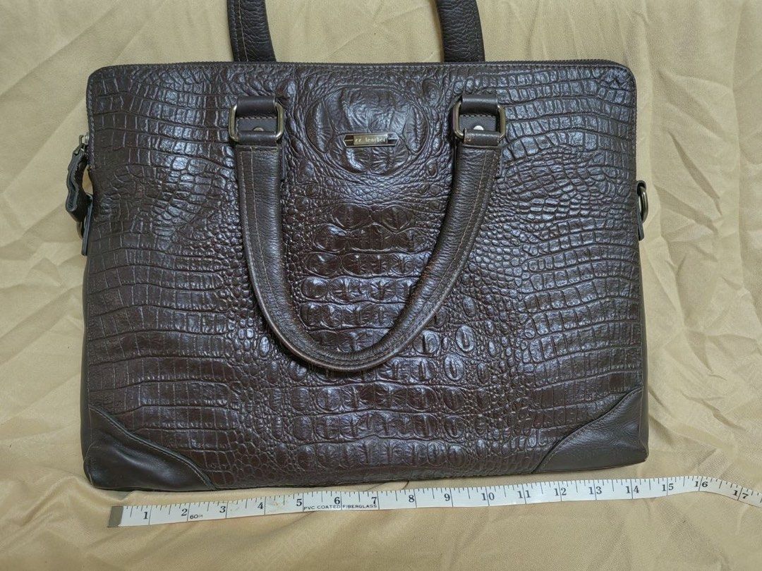 Brown Crocodile Embossed Leather Laptop Bag (Category: Laptop Bags & Sleeves) located in Manila. Submitted by junejanuary (Listing ID 1458500212, Image 1). Description: - Dark brown leather laptop bag - Crocodile embossed texture - Sturdy top handles - Detachable shoulder strap - Zip-top main compartment - Ample space for laptop and work essentials - Classic and professional design.