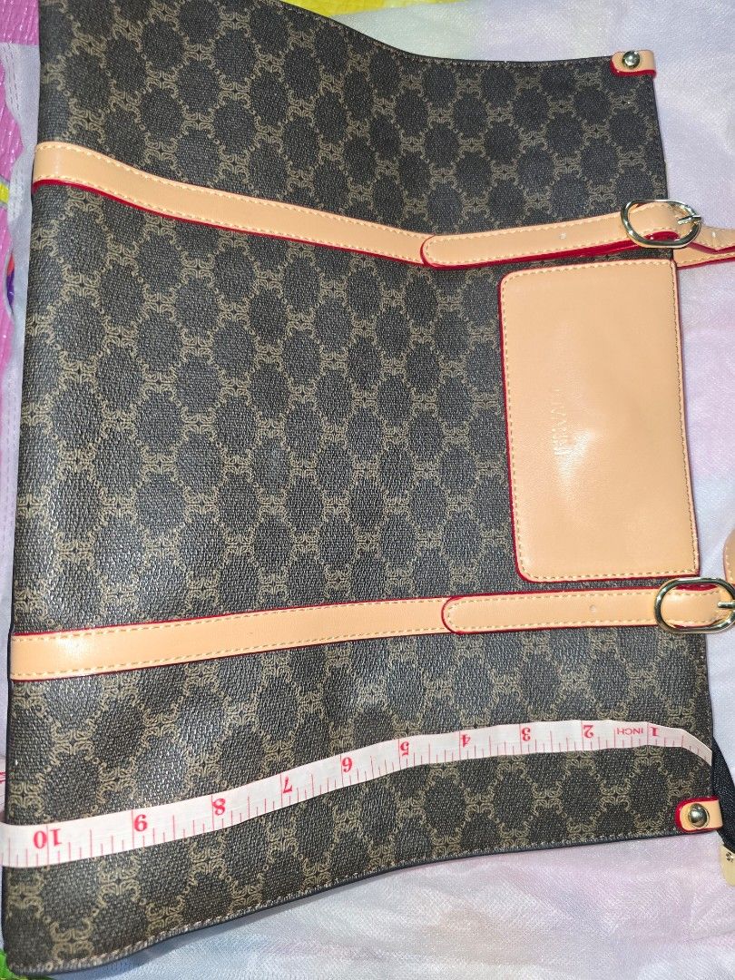 Brown Shoulder Bag with accents (Category: Tote Bags) located in Marikina City. Submitted by ynnaaaa (Listing ID 1458688790, Image 3). Description: - Spacious tote bag with classic monogram print - Elegant leather accents and striking red trim - Multiple interior compartments, including a secure zippered section - Comfortable top handles for easy carrying - Dimensions: Approximately 13 inches wide x 10 inches tall - Ideal for everyday use and err