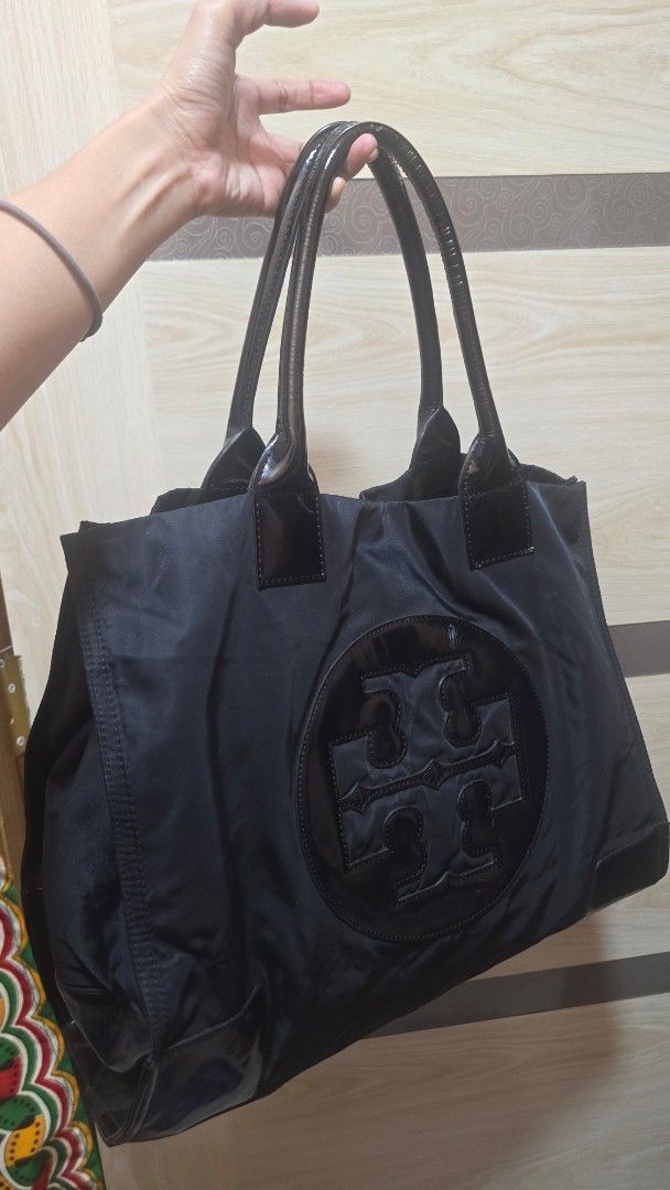 Bundle‼️ MCM/ Tory Burch Preloved (Category: Luxury Bags & Wallets) located in Quezon City. Submitted by mbpreloved65 (Listing ID 1458625077, Image 2). Description: - Authentic MCM tote bag - Signature Visetos print - Colorful lion emblem on the front - Deep purple leather trim and handles - Grey fabric interior lining - Secure zipper closure - Includes authenticity tag - Spacious and stylish for everyday use.