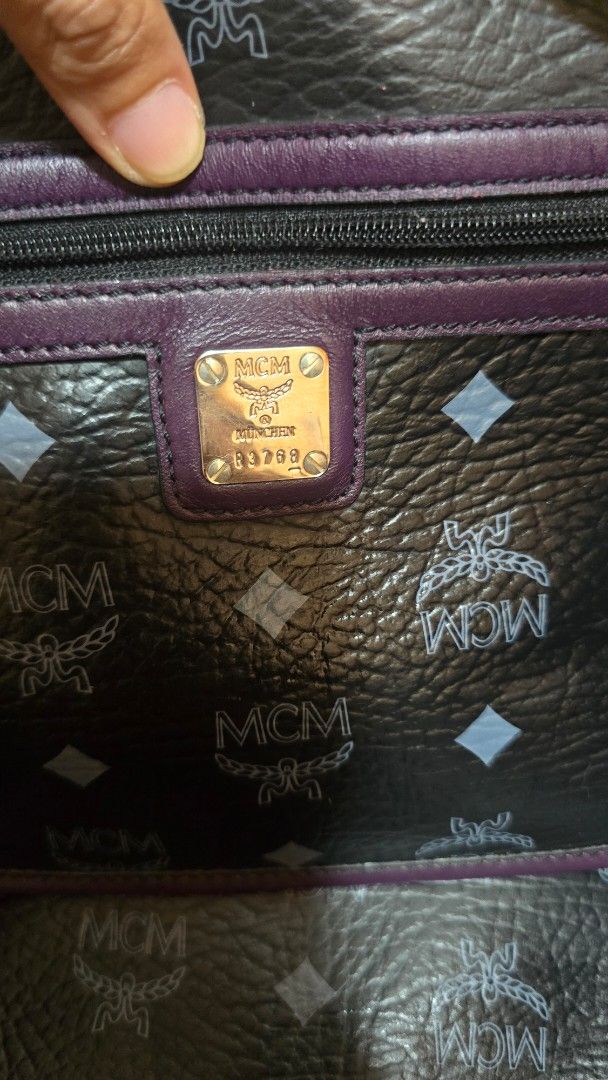 Bundle‼️ MCM/ Tory Burch Preloved (Category: Luxury Bags & Wallets) located in Quezon City. Submitted by mbpreloved65 (Listing ID 1458625077, Image 3). Description: - Authentic MCM tote bag - Signature Visetos print - Colorful lion emblem on the front - Deep purple leather trim and handles - Grey fabric interior lining - Secure zipper closure - Includes authenticity tag - Spacious and stylish for everyday use.