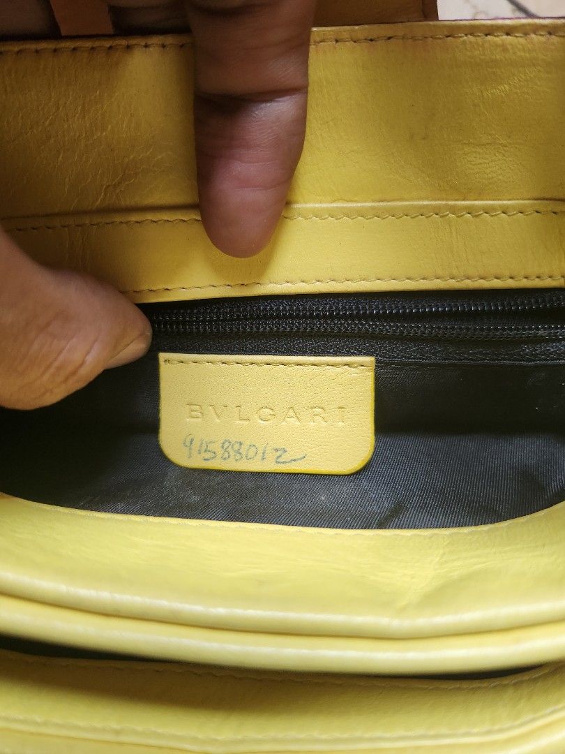 Bvlgari Monogram Canvas & Leather Shoulder Bag (Category: Luxury Bags & Wallets) located in Manila. Submitted by thritingera25 (Listing ID 1458585482, Image 2). Description: - Authentic Bvlgari shoulder bag - Color: Purple canvas with all-over BVLGARI logo print - Trim & Handles: Yellow leather - Interior: Black - Origin: Made in Italy - Features: Serial number visible inside - Style: A stylish and iconic accessory.