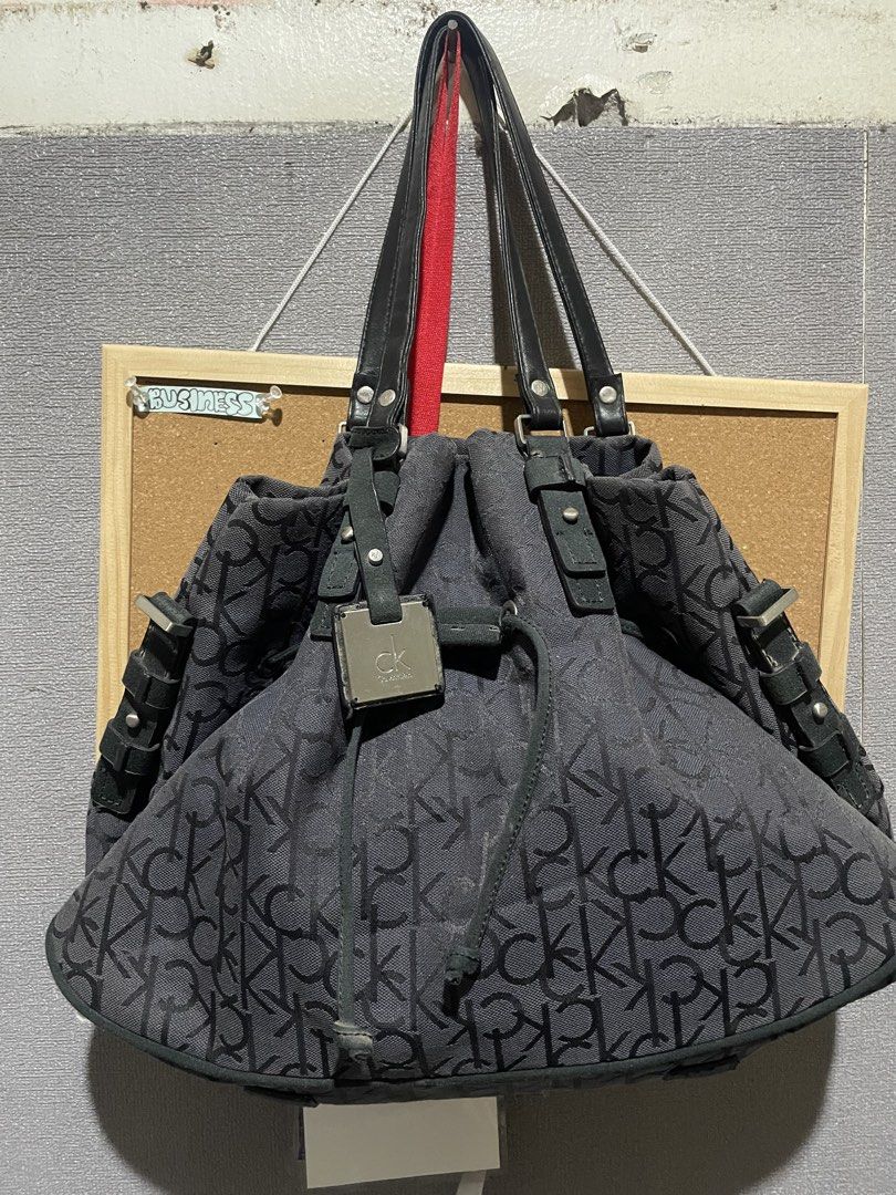 Calvin Klein CK Monogram Tote Bag (Category: Luxury Bags & Wallets) located in Manila. Submitted by beabohol0249530 (Listing ID 1458613174, Image 2). Description: - Classic Calvin Klein tote bag - All-over CK monogram print - Black and grey colorway - Genuine leather straps and details - Secure drawstring closure with metal hardware - Spacious interior for all your essentials - Ideal everyday bag.