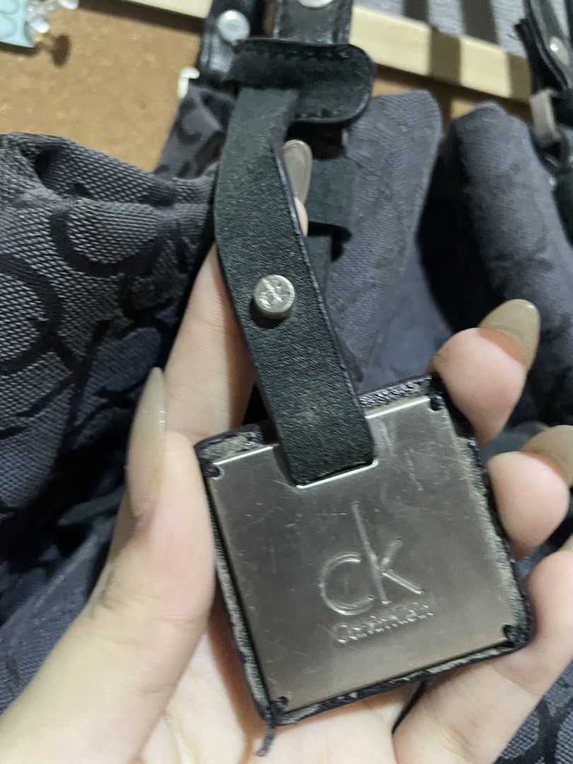 Calvin Klein CK Monogram Tote Bag (Category: Luxury Bags & Wallets) located in Manila. Submitted by beabohol0249530 (Listing ID 1458613174, Image 3). Description: - Classic Calvin Klein tote bag - All-over CK monogram print - Black and grey colorway - Genuine leather straps and details - Secure drawstring closure with metal hardware - Spacious interior for all your essentials - Ideal everyday bag.