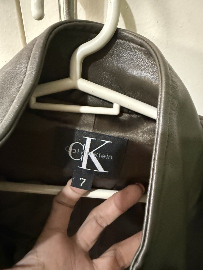 Calvin Klein Genuine Leather Jacket (Category: Coats, Jackets and Outerwear) located in Marikina City. Submitted by moonchok (Listing ID 1458523910, Image 3). Description: - Genuine dark moss green leather Calvin Klein jacket - Zip-up front with a high collar - Smooth satin lining - Ideal for layering - A timeless wardrobe essential - worn a few times! -very lightweight -comfy! -hard to let go ☹️ - rare bought in states for 15k -fits S to Semi M.