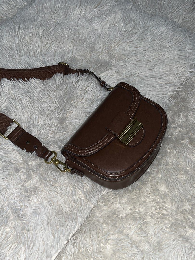 Charles & Keith Brown Shoulder Bag (Category: Shoulder Bags) located in Manila. Submitted by janellecr38883 (Listing ID 1458632235, Image 2). Description: - Brand: Charles & Keith - Color: Brown - Style: Classic shoulder bag - Hardware: Gold - Interior: Main compartment, 1 zippered pocket - Strap: Adjustable - Condition: Great for everyday use - Reason for Selling: Underused.