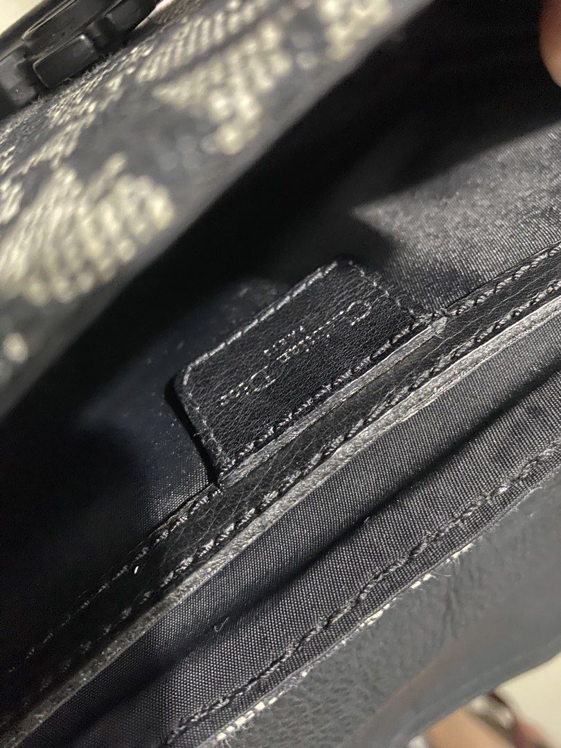 Christian Dior Saddle Bag Oblique Canvas (Category: Luxury Bags & Wallets) located in Manila. Submitted by hell_market (Listing ID 1458663738, Image 2). Description: - Iconic Dior Saddle Bag - Signature Oblique canvas (black & grey) - Black leather trim and strap - Classic CD buckle closure - Interior Dior leather tag - Stylish and practical for daily use.