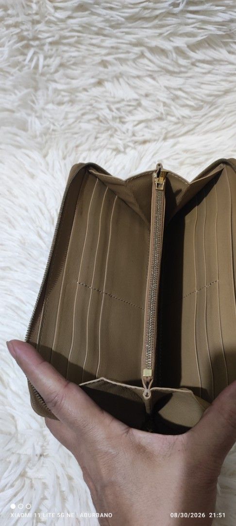 CÉLINE Bi-color Wallet (Category: Luxury Bags & Wallets) located in Makati City. Submitted by yerbua103 (Listing ID 1458642973, Image 2). Description: Celine bi-color leather zip-around long wallet in dark beige and black. Interior is leather and has a wide zip compartment, card slots and bills. Manage your expectations as you're buying a preloved wallet. .
