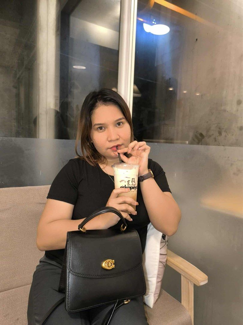 Coach Black Leather Top Handle Bag (Category: Luxury Bags & Wallets) located in Imus. Submitted by jemstoneee_ (Listing ID 1458523469, Image 3). Description: - Elegant black leather top handle bag - Features a secure gold turn-lock closure - Structured and sophisticated design - Versatile: can be carried by the top handle or worn as a crossbody - Ideal for both daily use and special occasions - In good, pre-loved condition.