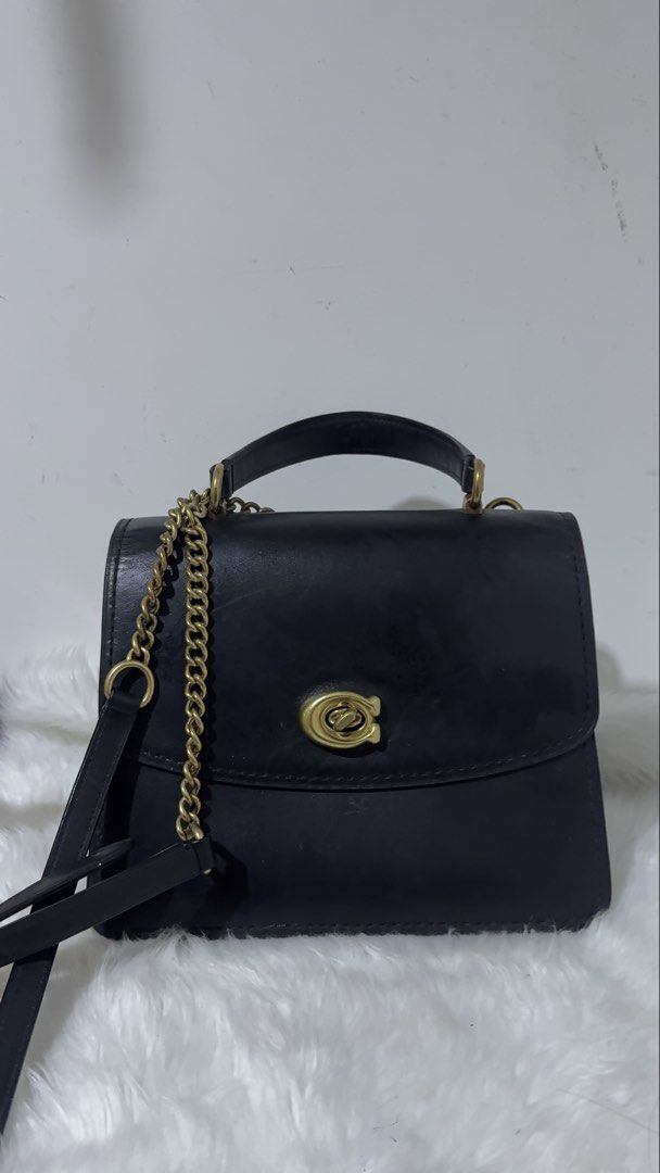 Coach Black Leather Top Handle Bag (Category: Luxury Bags & Wallets) located in Imus. Submitted by jemstoneee_ (Listing ID 1458523469, Image 1). Description: - Elegant black leather top handle bag - Features a secure gold turn-lock closure - Structured and sophisticated design - Versatile: can be carried by the top handle or worn as a crossbody - Ideal for both daily use and special occasions - In good, pre-loved condition.