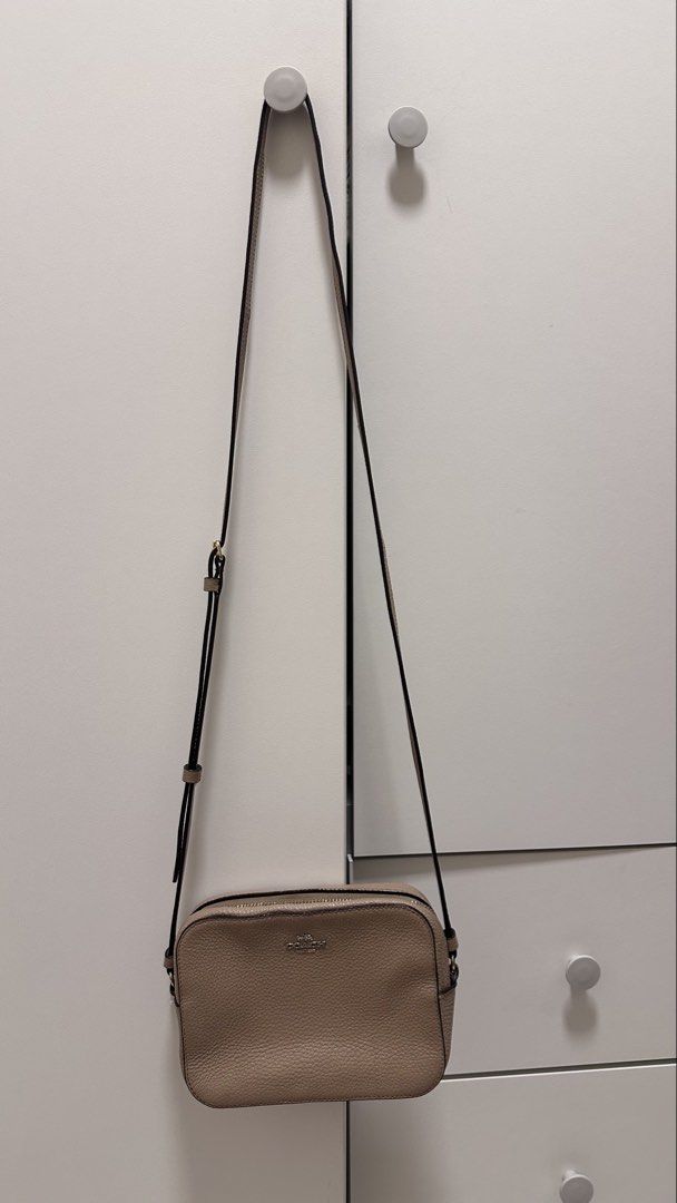 Coach Camera Bag in Taupe Pebbled Leather (Category: Cross-body Bags) located in Muntinlupa City. Submitted by shop.me.11 (Listing ID 1458626590, Image 2). Description: Authentic Coach camera bag in a soft taupe/beige pebbled leather with gold hardware. Compact crossbody silhouette — perfect for everyday use or travel when you want to go light..