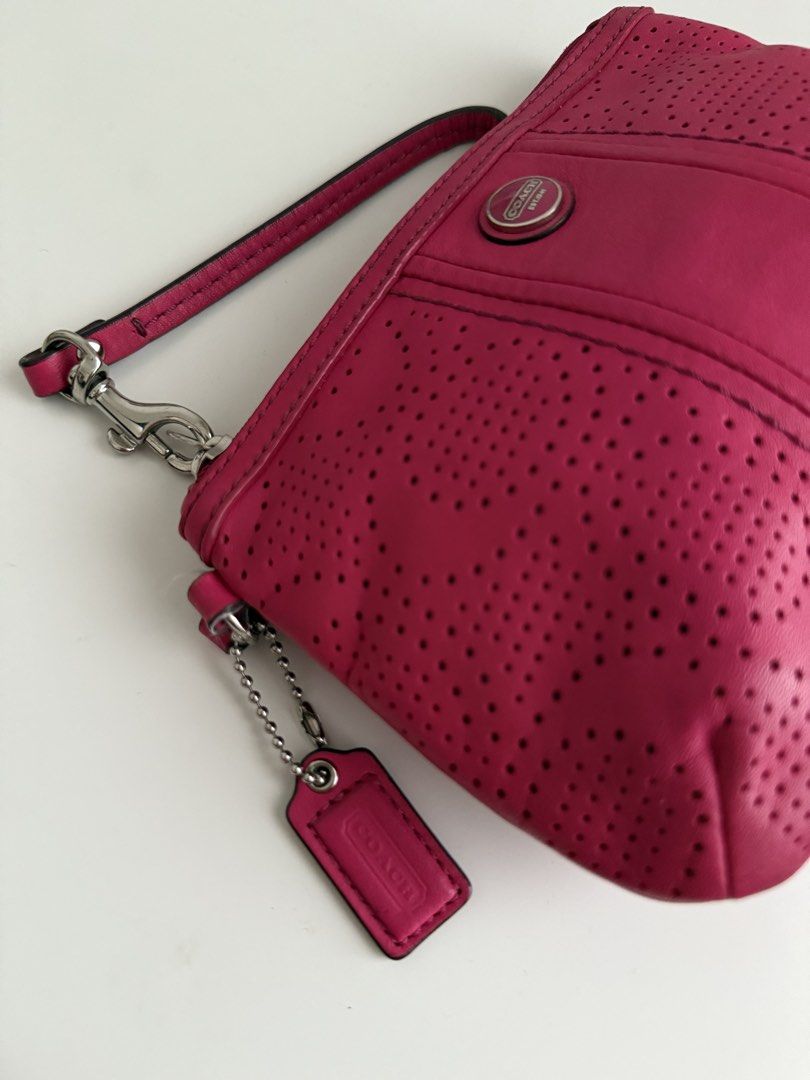 Coach Pink Wristlet (Category: Luxury Bags & Wallets) located in Quezon City. Submitted by 0ffTheRack (Listing ID 1458570684, Image 2). Description: - Genuine leather with perforated pattern - Silver hardware - 100% authentic.