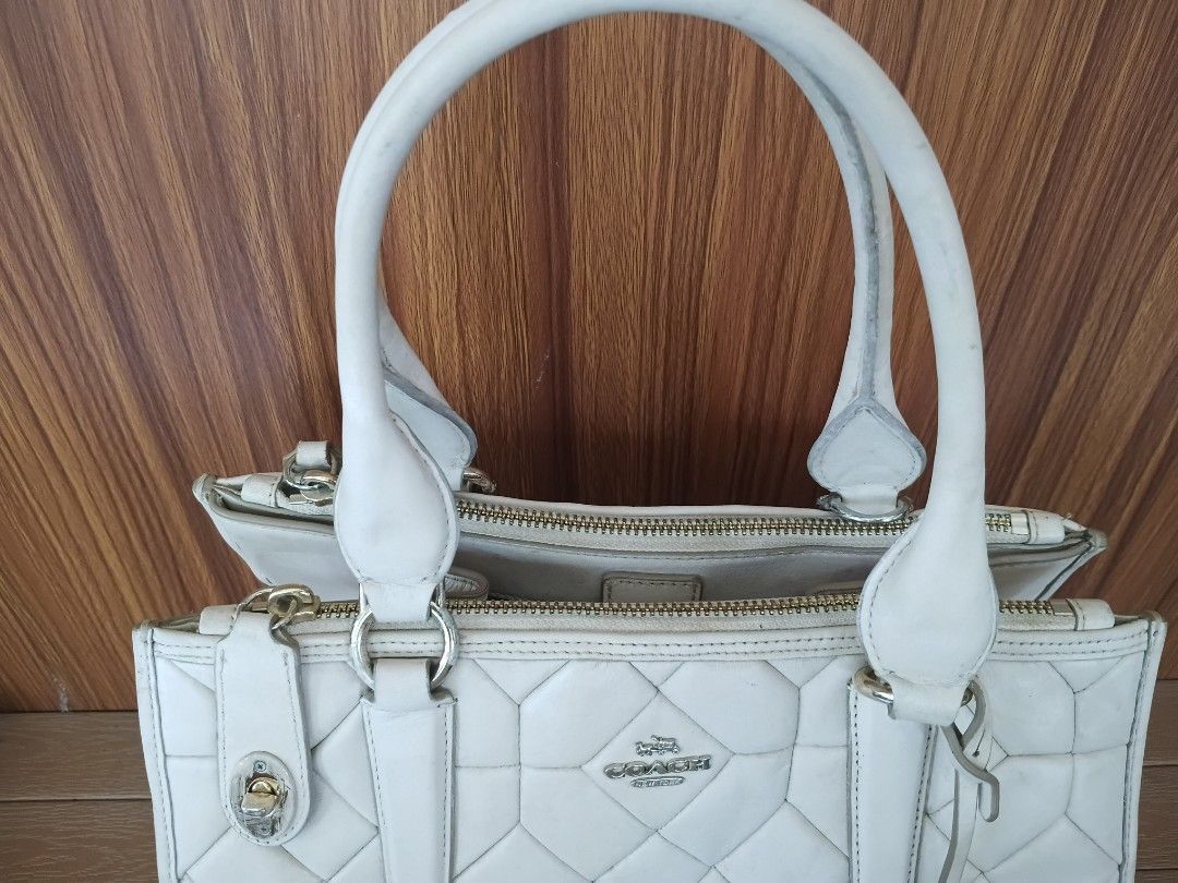 Coach Crosby Caryall Shoulder Bag (Category: Luxury Bags & Wallets) located in Davao. Submitted by sweet-sweet (Listing ID 1458576106, Image 3). Description: - Cream colored Coach tote bag - Quilted leather exterior with geometric pattern - Secure top zip closure - Multiple interior pockets for organization - Some stains present inside the main compartment - Comes with original Coach hang tag.