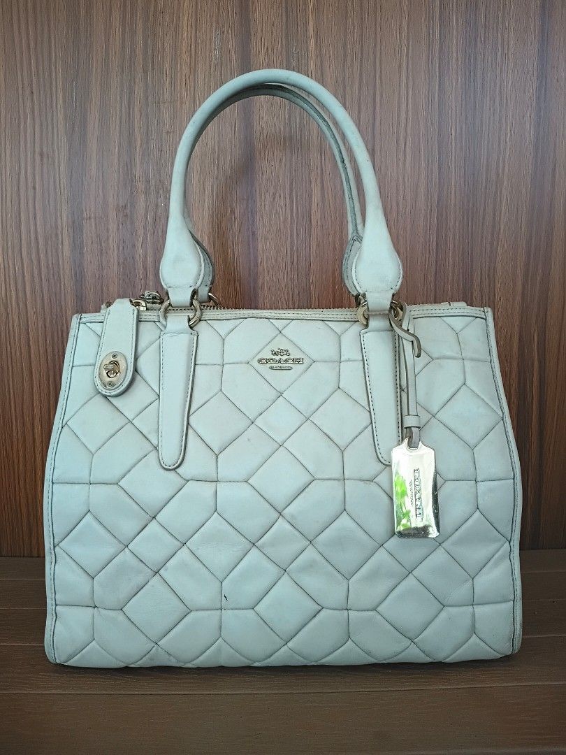 Coach Crosby Caryall Shoulder Bag (Category: Luxury Bags & Wallets) located in Davao. Submitted by sweet-sweet (Listing ID 1458576106, Image 1). Description: - Cream colored Coach tote bag - Quilted leather exterior with geometric pattern - Secure top zip closure - Multiple interior pockets for organization - Some stains present inside the main compartment - Comes with original Coach hang tag.