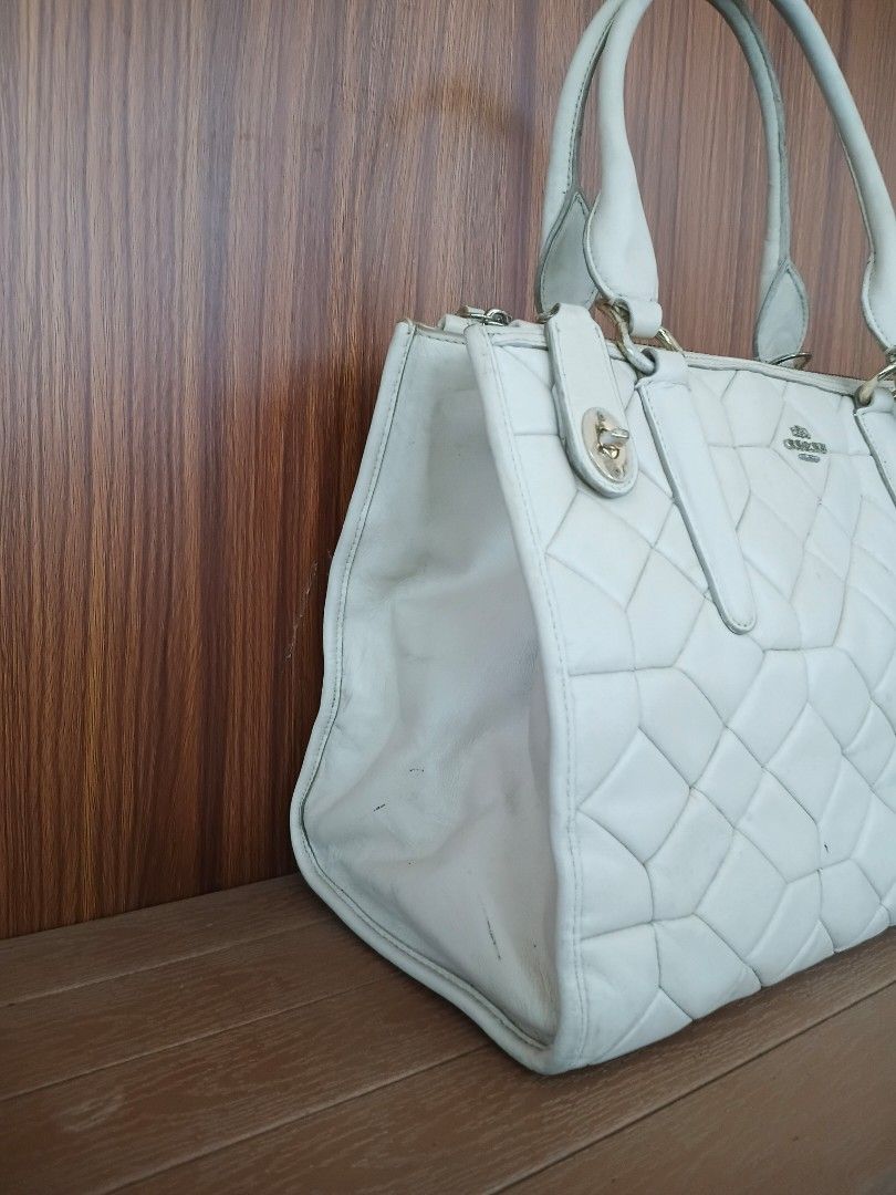 Coach Crosby Caryall Shoulder Bag (Category: Luxury Bags & Wallets) located in Davao. Submitted by sweet-sweet (Listing ID 1458576106, Image 2). Description: - Cream colored Coach tote bag - Quilted leather exterior with geometric pattern - Secure top zip closure - Multiple interior pockets for organization - Some stains present inside the main compartment - Comes with original Coach hang tag.