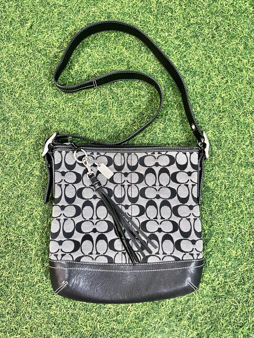 Coach Signature Soft Slim Duffle Bag (Category: Luxury Bags & Wallets) located in Nagcarlan. Submitted by prelovedbymayen (Listing ID 1458589407, Image 1). Description: Vintage Coach Signature Soft Slim Duffle bag Typically cataloged under model style number 9362. This classic Y2K-era crossbody and shoulder bag features Coach’s iconic interlocking “C” monogram jacquard canvas in a black and gray colorway. It is accented with smooth black leather 