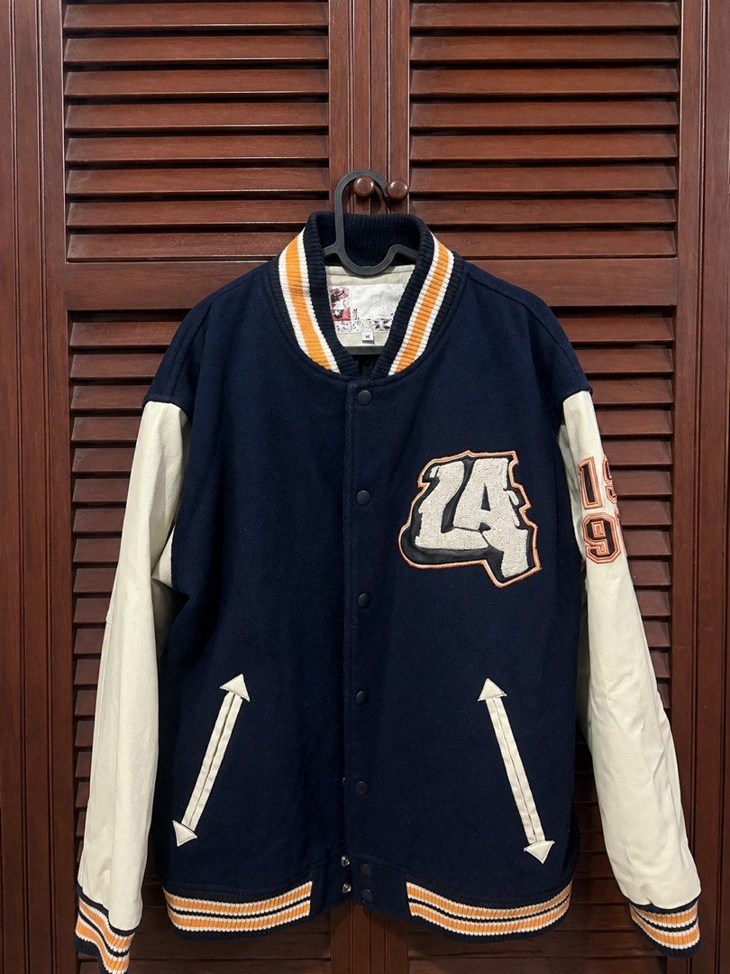 CONART LA 1997 Varsity Jacket (Category: Coats, Jackets and Outerwear) located in Mabalacat. Submitted by maebirayd (Listing ID 1458626802, Image 1). Description: - Classic CONART varsity jacket - Wool body with leather sleeves - 'LA' embroidered on the front - Back features 'CONART FROM THE PLANET OF DOPE SHIT' with Native American graphic - Orange and white striped cuffs and collar - Button-up closure - Perfect for collectors.