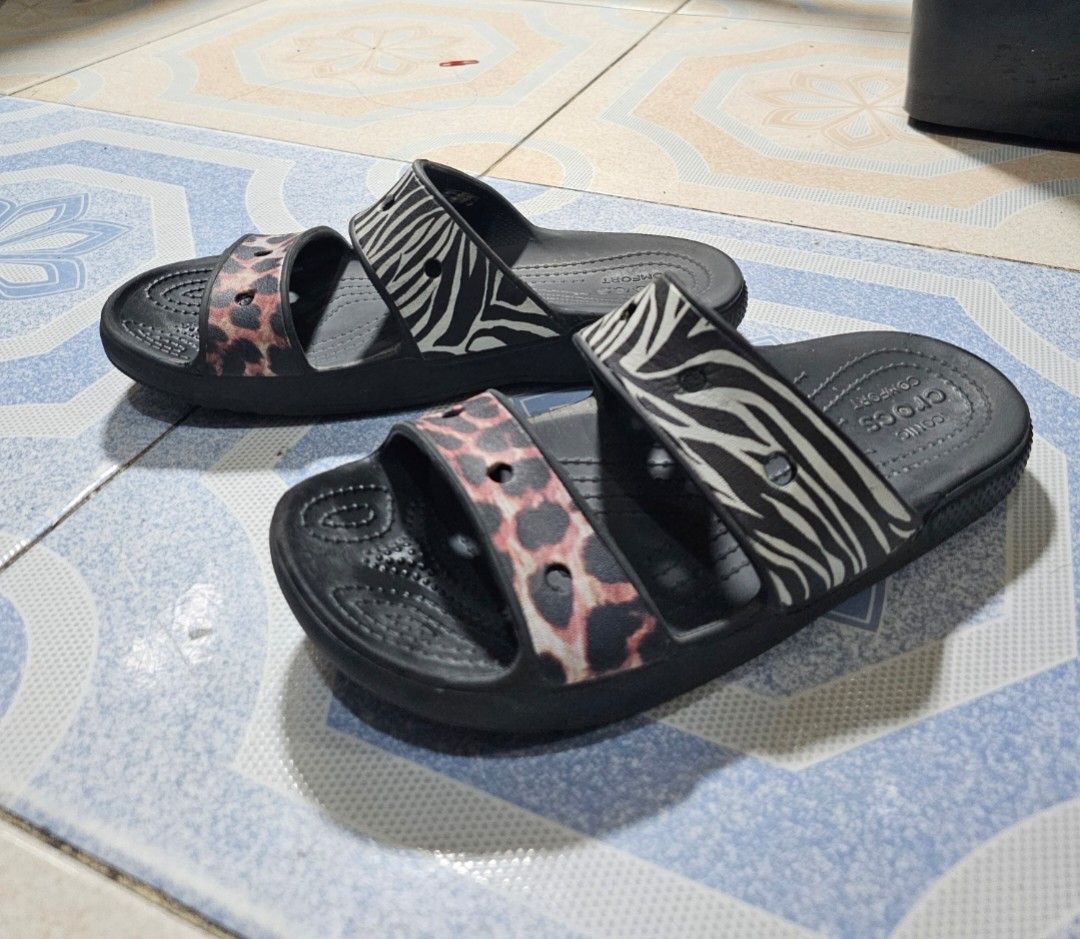 Crocs Two-Strap Slides Sandals Zebra Leopard Print size M6/M8 (Category: Flats & Sandals) located in Manila. Submitted by mamaloverakkie (Listing ID 1458671190, Image 2). Description: AUTHENTICITY STICKER ARE STILL INTACT❗️❗️❗️ - Black Crocs slides - Fun zebra and leopard print design - Two straps across the top - Comfortable and easy to slip on - Perfect for casual wear or by the pool - Shows some signs of wear, but plenty of life left.