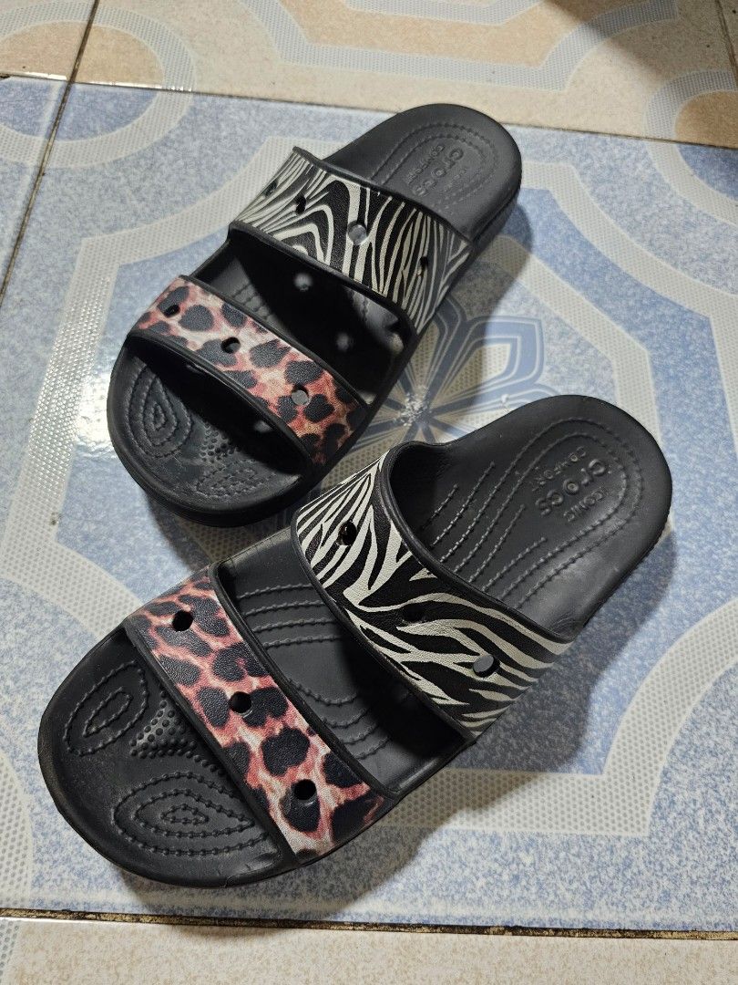 Crocs Two-Strap Slides Sandals Zebra Leopard Print size M6/M8 (Category: Flats & Sandals) located in Manila. Submitted by mamaloverakkie (Listing ID 1458671190, Image 3). Description: AUTHENTICITY STICKER ARE STILL INTACT❗️❗️❗️ - Black Crocs slides - Fun zebra and leopard print design - Two straps across the top - Comfortable and easy to slip on - Perfect for casual wear or by the pool - Shows some signs of wear, but plenty of life left.
