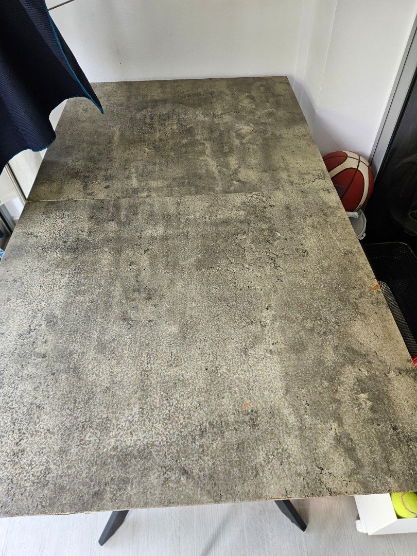 Extendable Dining Table (Category: Tables & Sets) located in Singapore. Submitted by rayne8 (Listing ID 1458578359, Image 3). Description: - Dining table with a unique concrete-like finish - Textured, mottled grey tabletop - Versatile: perfect for dining or as a workspace - Features sturdy black metal legs - Length 140cm - 180cm (extendable) - Width 80cm.