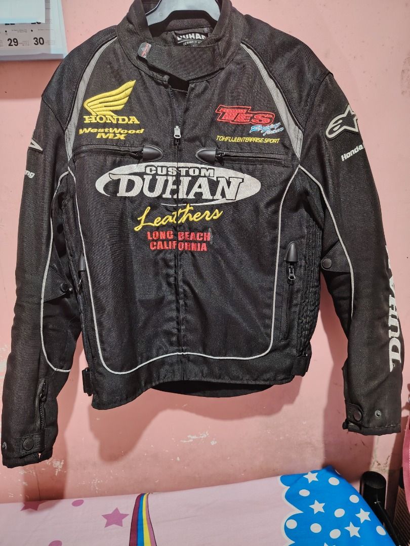 DUHAN Custom Leathers Motorcycle Jacket Long Beach California (Category: Coats, Jackets and Outerwear) located in Caloocan City. Submitted by wisedragon_31f86a (Listing ID 1458544143, Image 1). Description: - Black DUHAN motorcycle jacket - Features 'Custom DUHAN Leathers' and 'Long Beach California' graphics - Includes Honda and other racing patches - Front zip closure - Ideal for motorcycle riding.