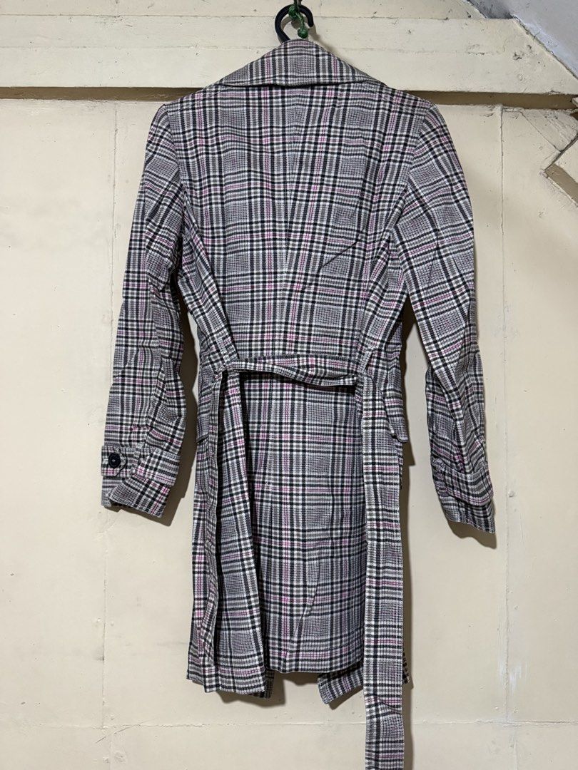 Esprit Collection Plaid Double-Breasted Trench Coat (Category: Coats, Jackets and Outerwear) located in Makati City. Submitted by refind.prelove.finds (Listing ID 1458647827, Image 3). Description: - Classic plaid trench coat - Double-breasted design - Belted waist for a cinched look - Knee length - Features a stylish pink lining - Ideal for layering and adding a sharp, stylish touch to any outfit.