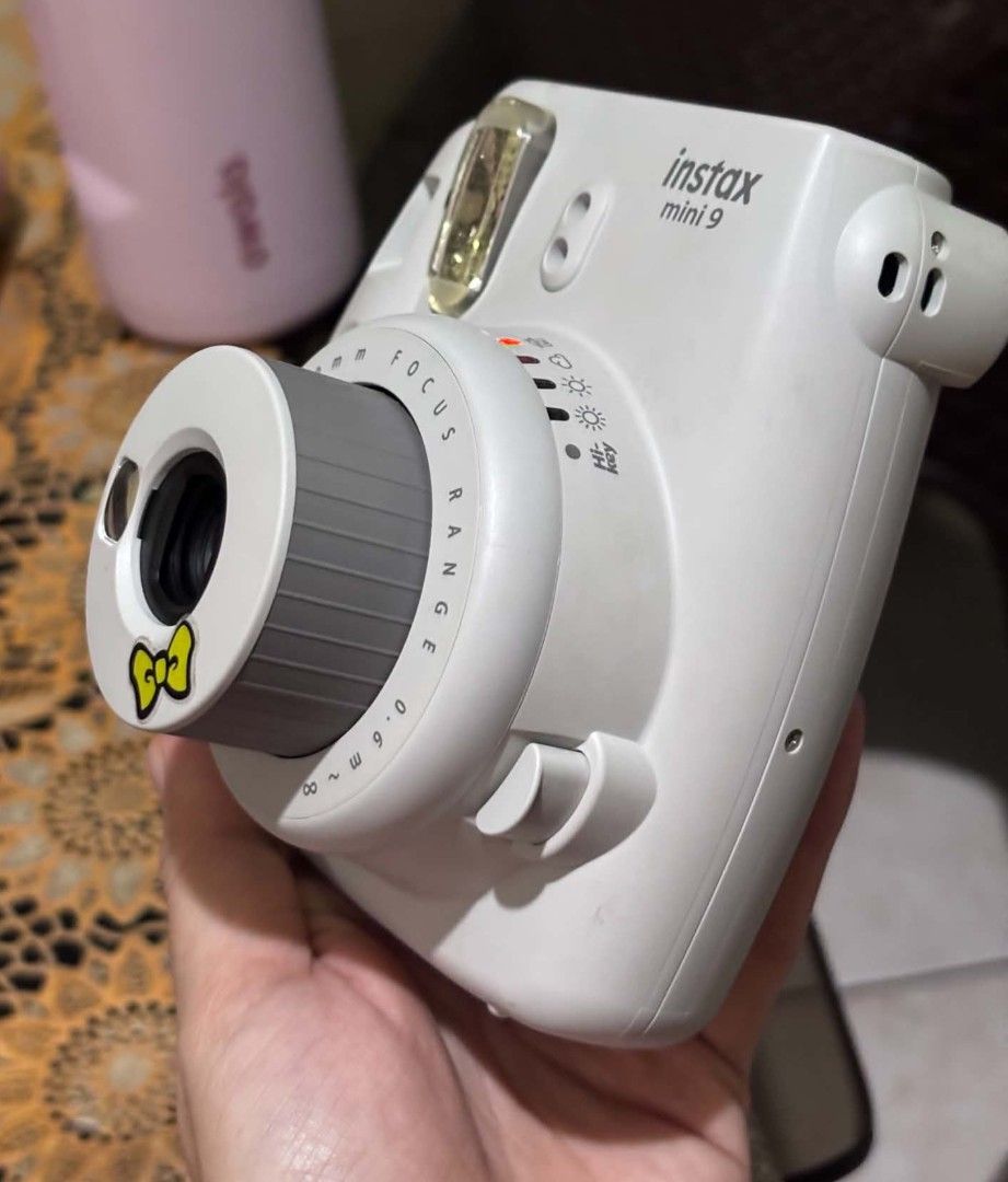 Fujifilm Instax Mini 9 Instant Camera - White (Category: Cameras) located in Manila. Submitted by jane_015 (Listing ID 1458552415, Image 3). Description: - Fujifilm Instax Mini 9 camera - Features a cute yellow bow sticker on the lens - Ideal for taking instant photos - Simple point-and-shoot functionality - Perfect for capturing memories on your adventures ✨ Original Fujifilm Instax Mini 9 📷 Perfect for photos, events, travel & gifts 💗 Cute an