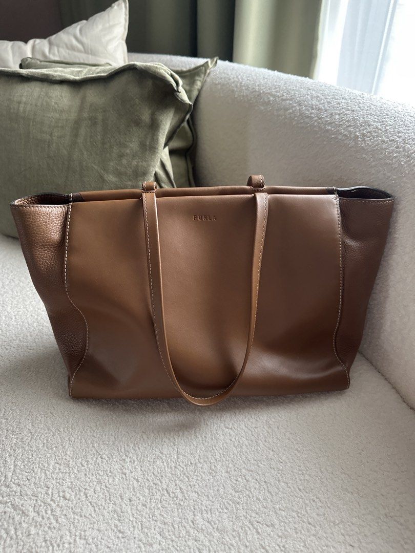 Furla Leather Tote Bag - Brown (Category: Luxury Bags & Wallets) located in Caloocan City. Submitted by dmqwear (Listing ID 1458568205, Image 1). Description: - Authentic Furla brown leather tote bag - Pebbled leather sides, smooth leather front/back - Secure zip closure - Spacious interior for all your essentials - Four protective metal feet on the bottom - Heavily used thus the wear on top edges near the zipper but this can be refurbished.