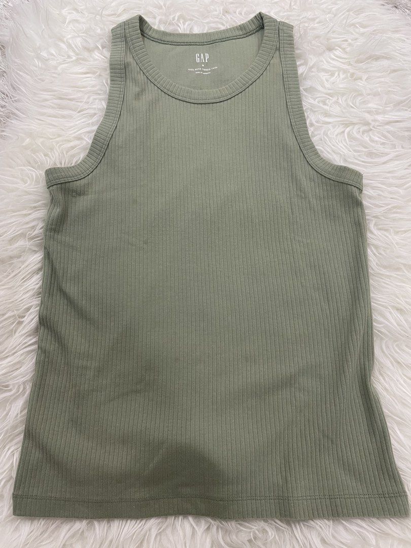 GAP Ribbed Tank Top - Sage Green - Size M (Category: Sleeveless) located in Quezon City. Submitted by TGDL123 (Listing ID 1458587241, Image 1). Description: - Sage green ribbed tank top from GAP - Comfortable cotton blend with added spandex for stretch - Stylish racerback design - Versatile basic piece, ideal for layering or wearing on its own.