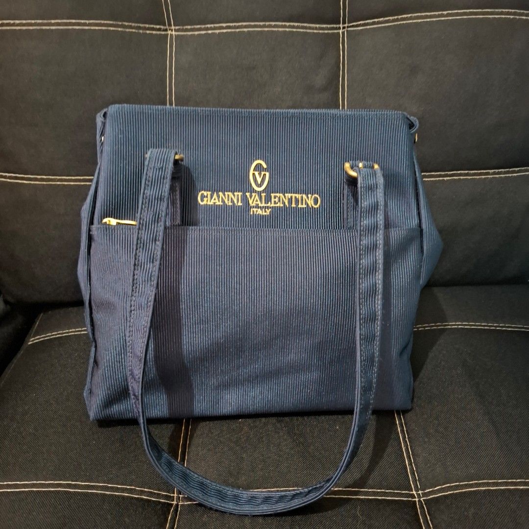 Gianni Valentino Navy Blue Bag (Category: Shoulder Bags) located in Baliuag. Submitted by ahgashop. (Listing ID 1458535428, Image 1). Description: - Navy blue Gianni Valentino bag from Japan - Features elegant gold hardware - Unique textured design and spacious - Ideal for everyday use.