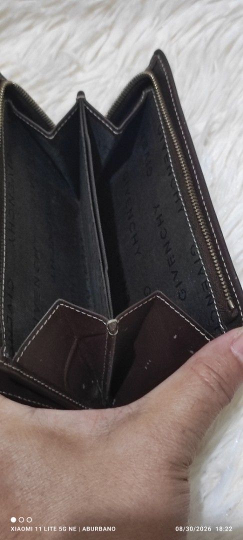 GIVENCHY (Portefeuille Marron) (Category: Luxury Bags & Wallets) located in Makati City. Submitted by yerbua103 (Listing ID 1458605779, Image 3). Description: Brown Givenchy monogram canvas bifold wallet featuring a geometric 4G logo pattern and a gold-tone brand plaque. Manage your expectations as youre buying a preloved wallet. Hairlines on the logo plaque .