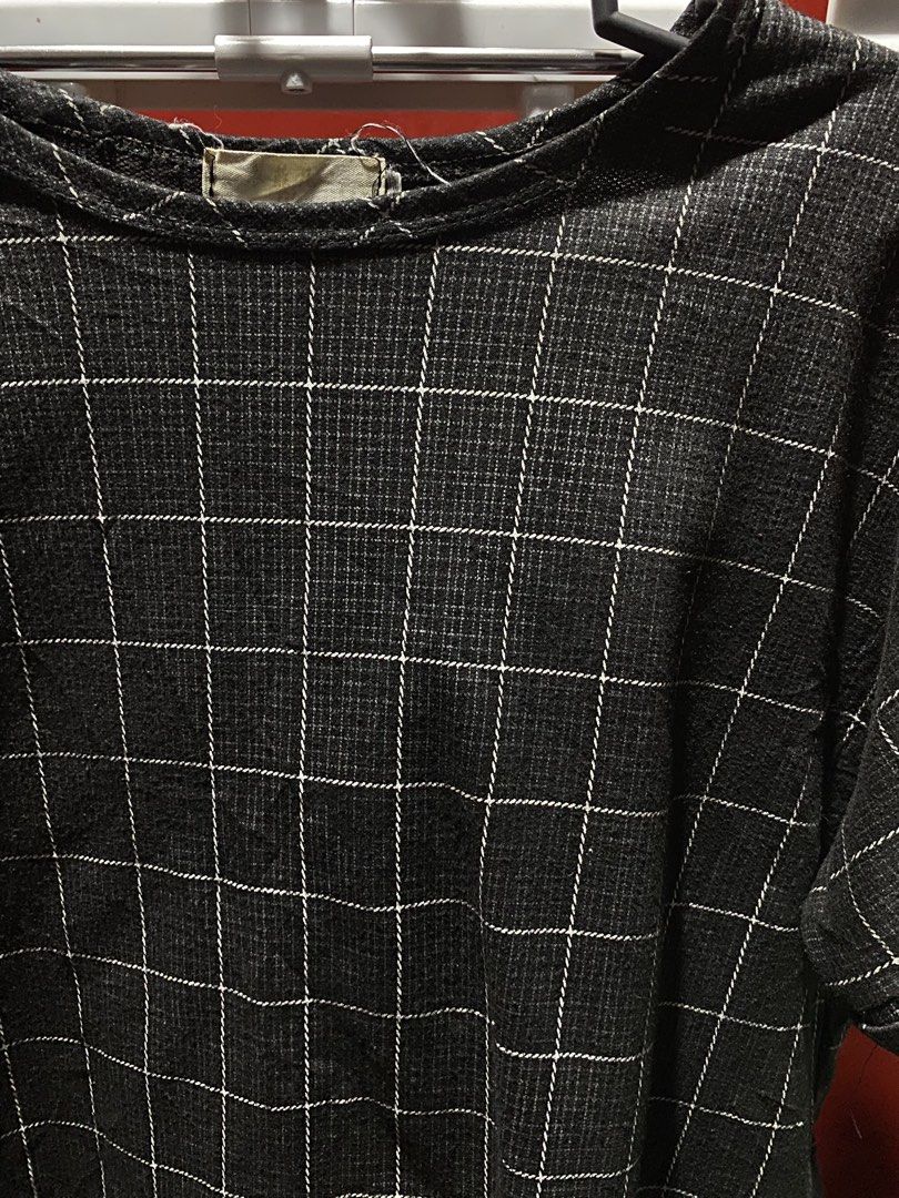 Grey Plaid Short Sleeve Top (Category: Blouses) located in Bauang. Submitted by nrrandomthings (Listing ID 1458659089, Image 2). Description: - Grey top with a chic white grid pattern. - Features short sleeves with a stylish rolled cuff. - Classic round neckline for a versatile look. - Comfortable textured fabric, ideal for daily wear. - Effortlessly pairs with jeans or skirts for various outfits..