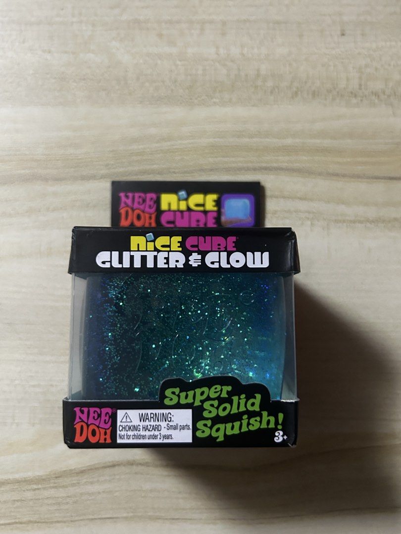 GUARANTEED AUTHENTIC:Schylling Nee Doh Nice Cube by Glitter & Glow Super Solid Squish Toy (Category: Interactive Toys) located in Pateros City. Submitted by thesisties (Listing ID 1458587865, Image 1). Description: -Bought from US - Nee Doh Nice Cube: Glitter & Glow Edition - Super solid yet satisfyingly squishy texture - Features shimmering glitter and glows in the dark - Excellent sensory toy for stress relief and fidgeting - Perfect for both k