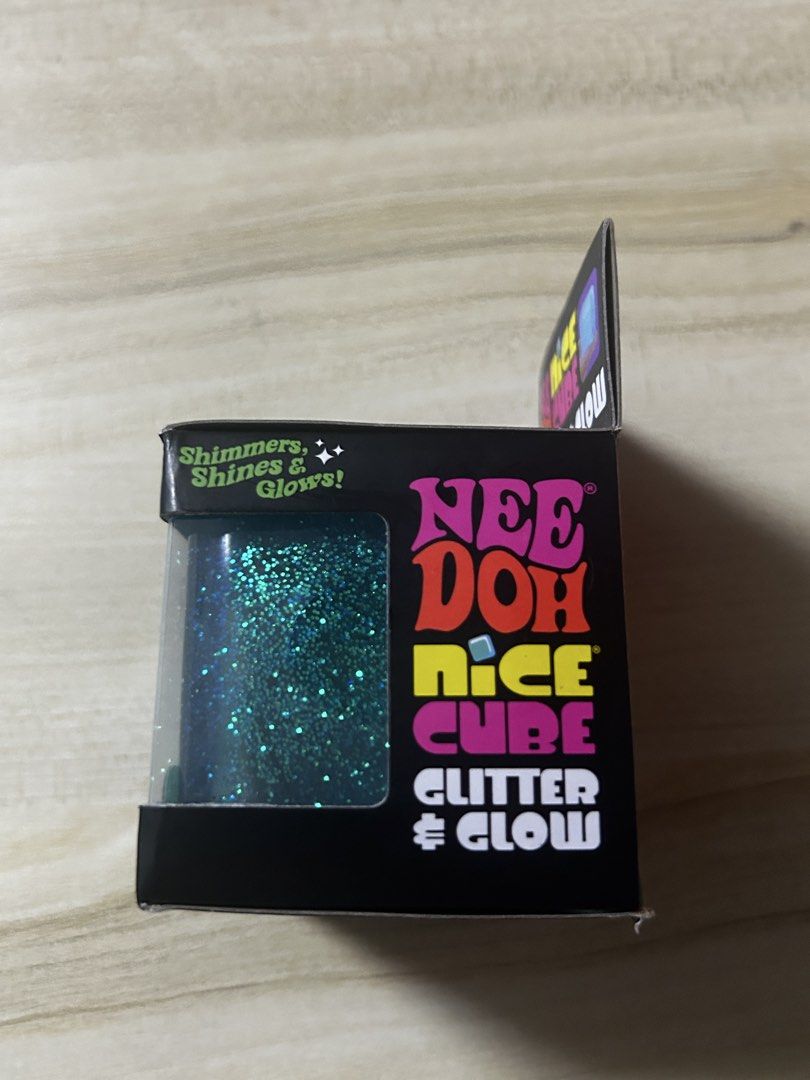 GUARANTEED AUTHENTIC:Schylling Nee Doh Nice Cube by Glitter & Glow Super Solid Squish Toy (Category: Interactive Toys) located in Pateros City. Submitted by thesisties (Listing ID 1458587865, Image 3). Description: -Bought from US - Nee Doh Nice Cube: Glitter & Glow Edition - Super solid yet satisfyingly squishy texture - Features shimmering glitter and glows in the dark - Excellent sensory toy for stress relief and fidgeting - Perfect for both k