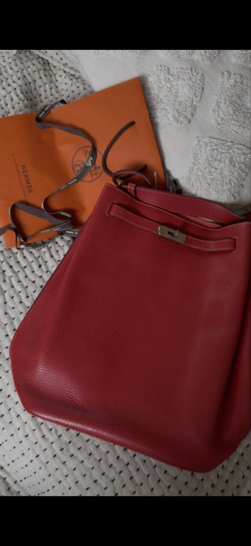 Hermes So Kelly (Category: Luxury Bags & Wallets) located in Quezon City. Submitted by kellypochette (Listing ID 1458584015, Image 1). Description: - Genuine red leather Hermes bag - Features elegant silver hardware closure - Comes with iconic Hermes orange shopping bag and ribbon - Versatile for daily use - Please note: Scarf tied to handle is not included .
