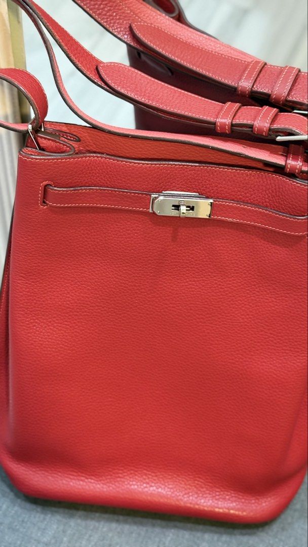 Hermes So Kelly (Category: Luxury Bags & Wallets) located in Quezon City. Submitted by kellypochette (Listing ID 1458584015, Image 3). Description: - Genuine red leather Hermes bag - Features elegant silver hardware closure - Comes with iconic Hermes orange shopping bag and ribbon - Versatile for daily use - Please note: Scarf tied to handle is not included .