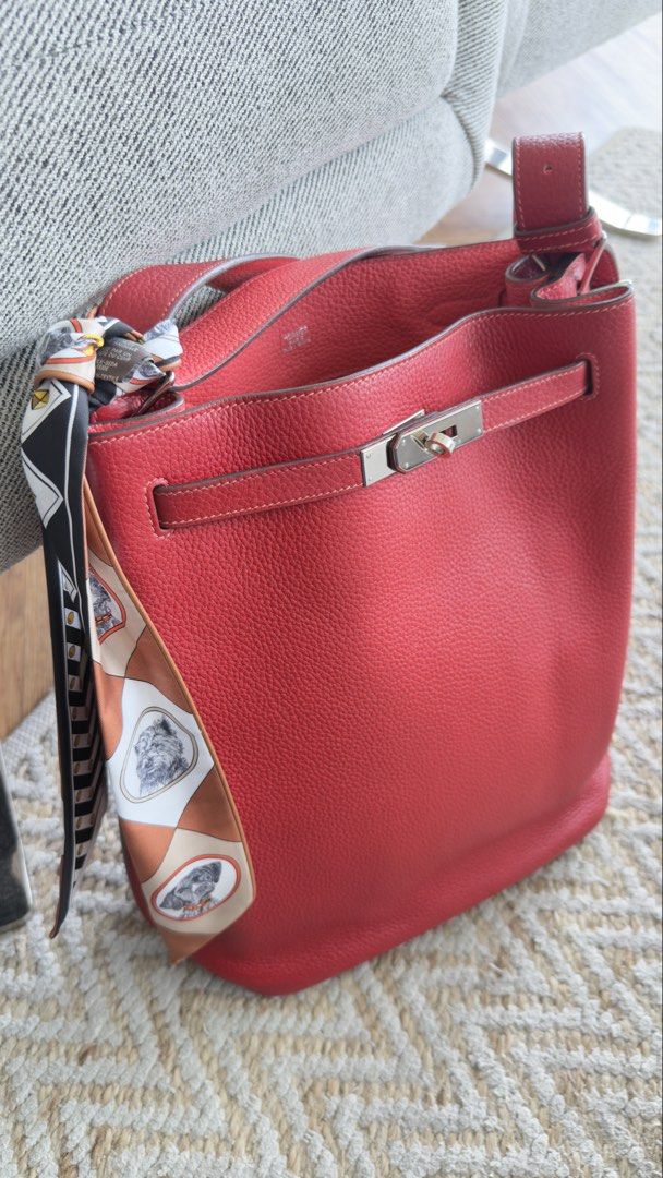 Hermes So Kelly (Category: Luxury Bags & Wallets) located in Quezon City. Submitted by kellypochette (Listing ID 1458584015, Image 2). Description: - Genuine red leather Hermes bag - Features elegant silver hardware closure - Comes with iconic Hermes orange shopping bag and ribbon - Versatile for daily use - Please note: Scarf tied to handle is not included .