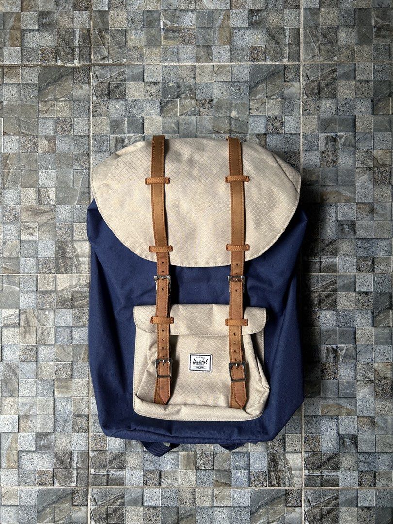 Herschel Supply Co. Backpack Navy Blue Tan (Category: Backpacks) located in Quezon City. Submitted by commonwealthpickerph (Listing ID 1458522168, Image 1). Description: Herschel backpack in navy blue and tan - Spacious main compartment with drawstring closure - Front pocket with buckle straps for extra storage - Durable construction, great for daily use or travel - Plenty of room for your essentials - In good condition - Has sign of used - Issue