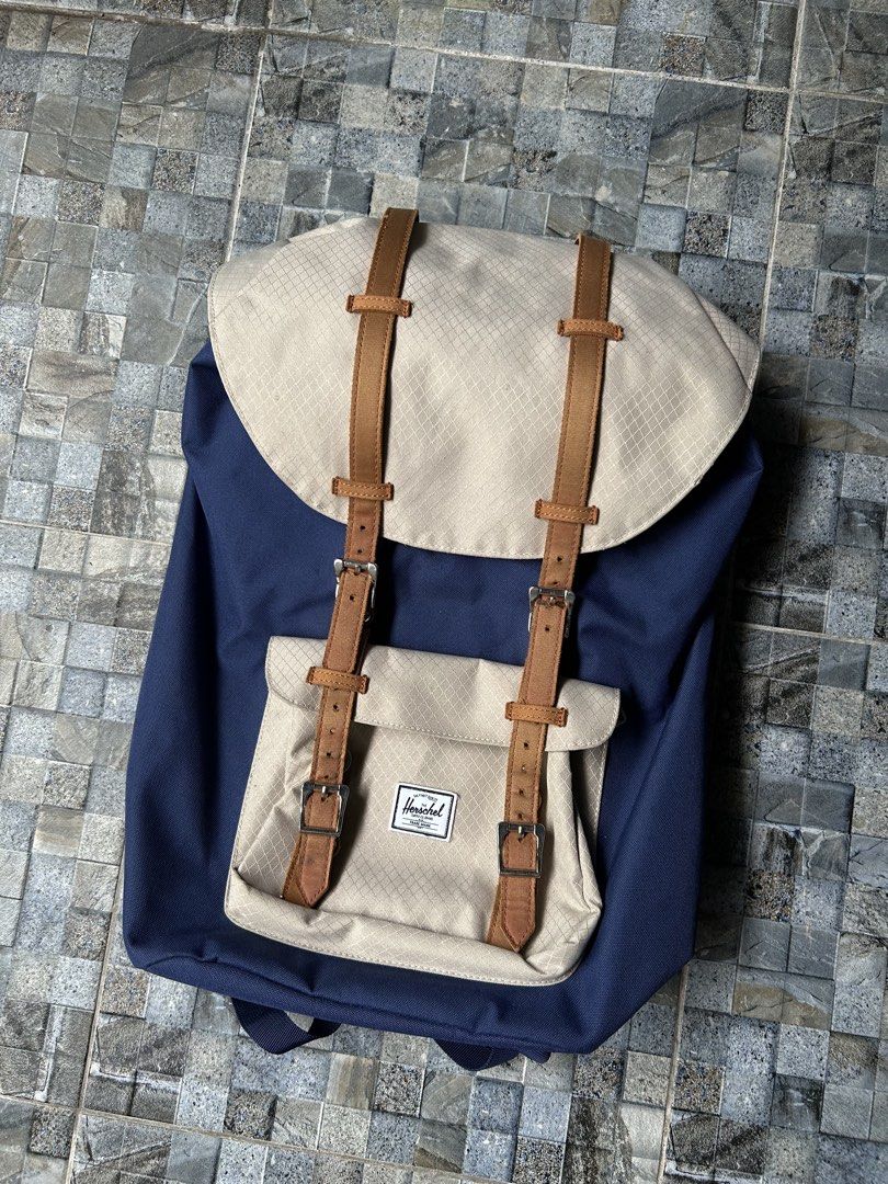 Herschel Supply Co. Backpack Navy Blue Tan (Category: Backpacks) located in Quezon City. Submitted by commonwealthpickerph (Listing ID 1458522168, Image 2). Description: Herschel backpack in navy blue and tan - Spacious main compartment with drawstring closure - Front pocket with buckle straps for extra storage - Durable construction, great for daily use or travel - Plenty of room for your essentials - In good condition - Has sign of used - Issue