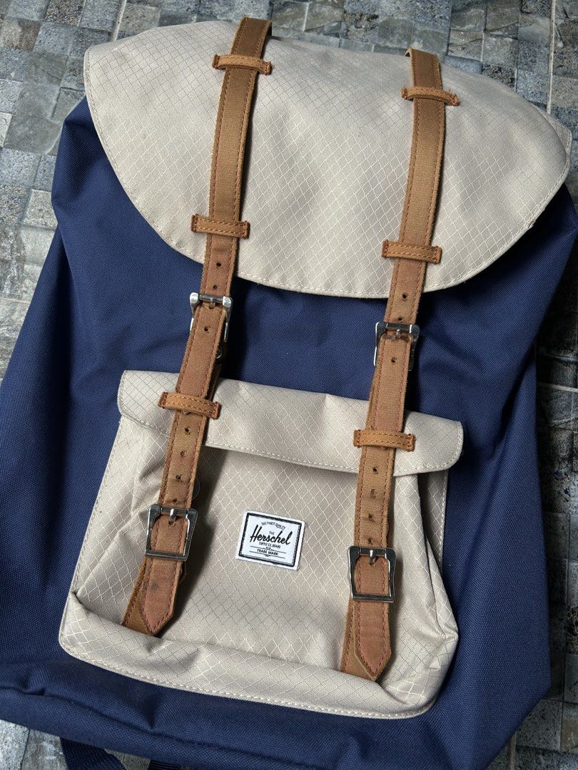 Herschel Supply Co. Backpack Navy Blue Tan (Category: Backpacks) located in Quezon City. Submitted by commonwealthpickerph (Listing ID 1458522168, Image 3). Description: Herschel backpack in navy blue and tan - Spacious main compartment with drawstring closure - Front pocket with buckle straps for extra storage - Durable construction, great for daily use or travel - Plenty of room for your essentials - In good condition - Has sign of used - Issue