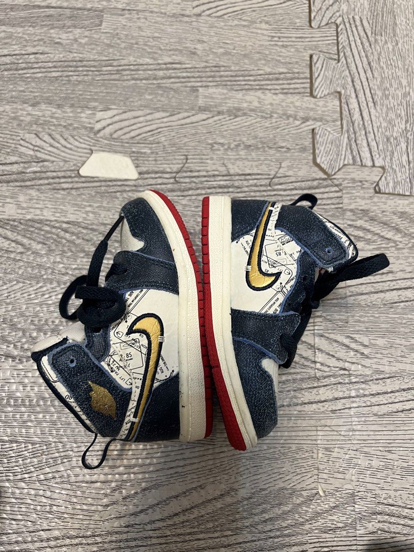 Jordan 1 High Toddler Shoes (Category: Babies & Kids Fashion) located in Caloocan City. Submitted by mahanne (Listing ID 1458548684, Image 2). Description: - Toddler Jordan 1 Highs - Size: 6C - Colorway: Navy, White, and Red - Unique map-like graphic on side panels - Navy laces - Red soles with Nike branding - Ideal for young sneaker enthusiasts.