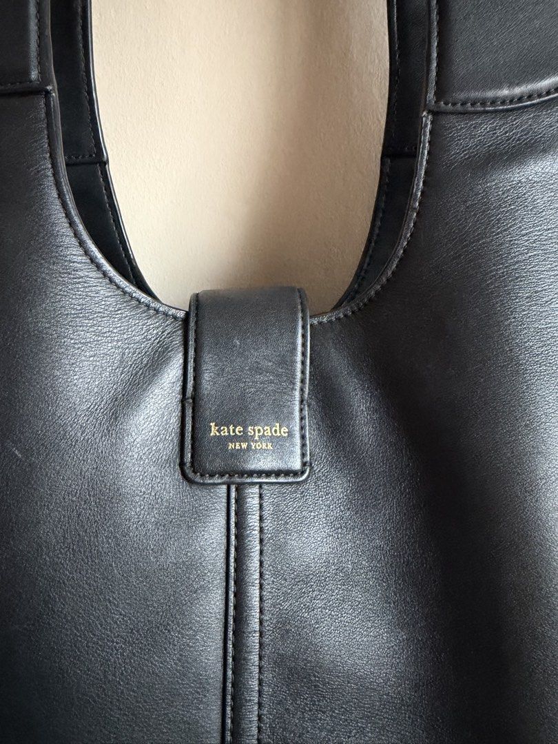 Kate Spade Black Leather Shoulder Bag (Category: Luxury Bags & Wallets) located in Manila. Submitted by nicauliflower77 (Listing ID 1458535127, Image 3). Description: - Authentic Kate Spade New York black leather shoulder bag - Features a central buckle with embossed Kate Spade logo - Comfortable shoulder straps for easy wear - Classic, versatile design ideal for daily use - Note: Minor marks present on the exterior leather, especially the lower 