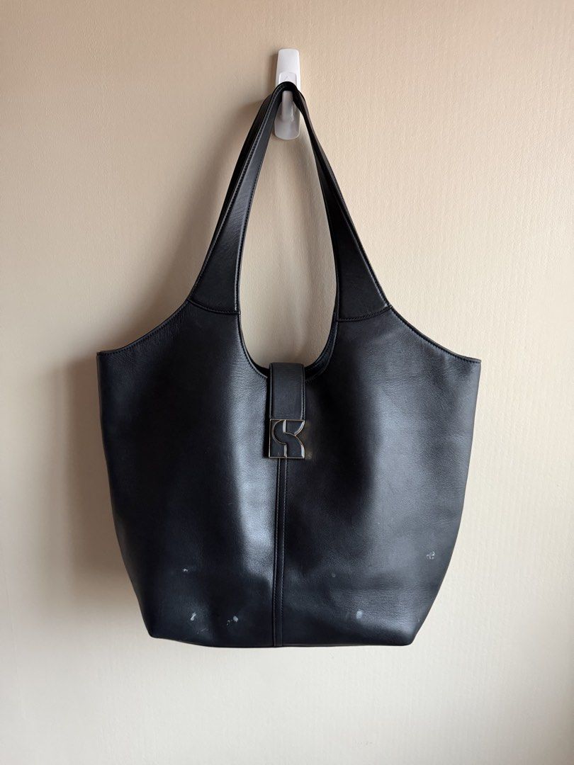 Kate Spade Black Leather Shoulder Bag (Category: Luxury Bags & Wallets) located in Manila. Submitted by nicauliflower77 (Listing ID 1458535127, Image 2). Description: - Authentic Kate Spade New York black leather shoulder bag - Features a central buckle with embossed Kate Spade logo - Comfortable shoulder straps for easy wear - Classic, versatile design ideal for daily use - Note: Minor marks present on the exterior leather, especially the lower 