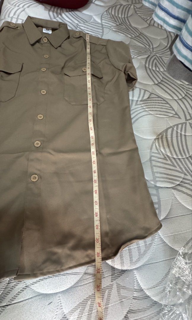 Khaki Short Sleeve Button-Up Shirt with Pockets (Category: Tshirts & Polo Shirts ) located in Bacoor. Submitted by _ibyangf (Listing ID 1458602820, Image 3). Description: - Khaki to brown short sleeve button-up shirt - Two chest pockets with button closures - Button-down front - Shoulder epaulets - Measurements on photos - Please check measurements before purchasing I have 8 of these, all Brand new, 2 medium, 2 Large, 5 XL. Khaki to Brown colors.