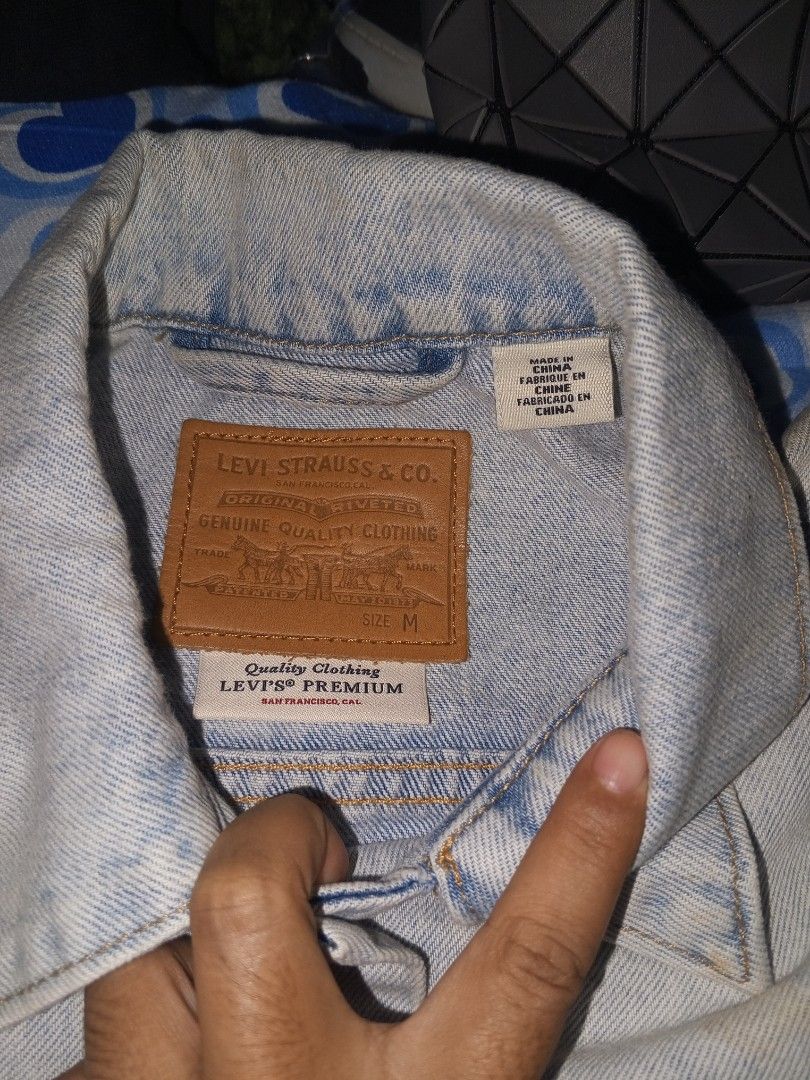 Levi's Strauss & Co. Patchwork Denim Jacket Size M (Category: Coats, Jackets and Outerwear) located in Magalang. Submitted by zeiansoria64090 (Listing ID 1458501401, Image 3). Description: - Classic Levi's denim jacket - Unique patchwork design with varied denim washes - Button-up front closure - Two chest pockets - Size: Medium - Ideal for layering - Versatile wardrobe staple.