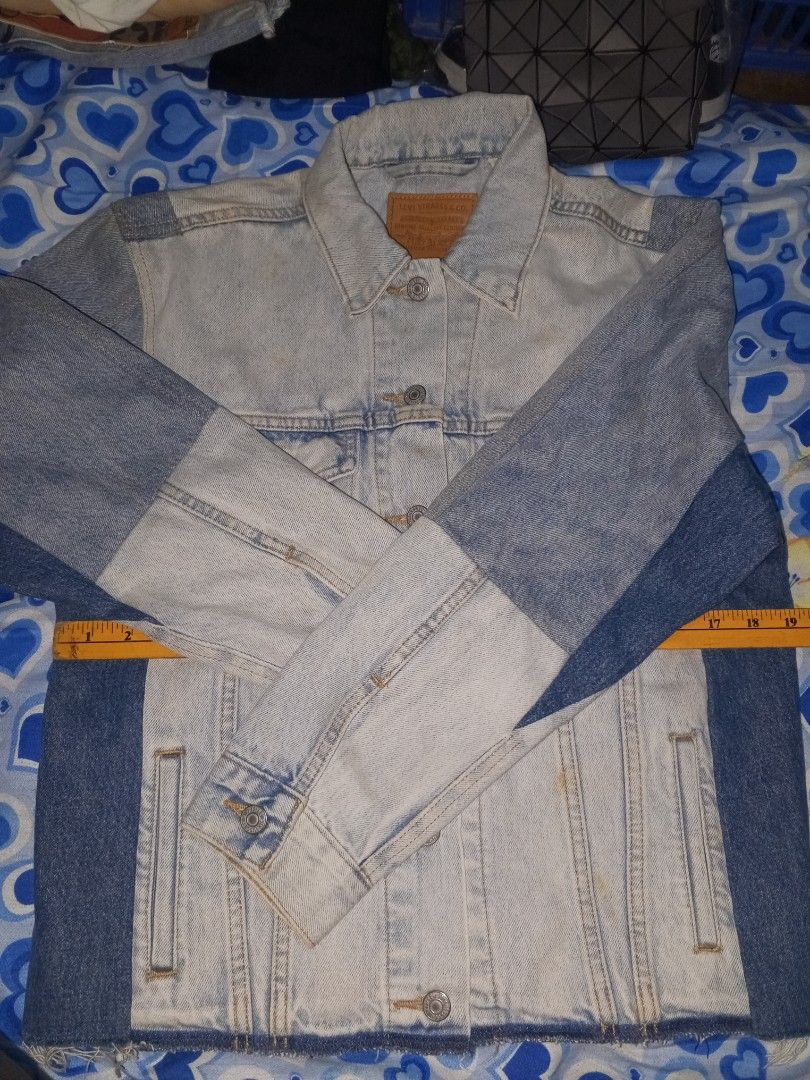 Levi's Strauss & Co. Patchwork Denim Jacket Size M (Category: Coats, Jackets and Outerwear) located in Magalang. Submitted by zeiansoria64090 (Listing ID 1458501401, Image 2). Description: - Classic Levi's denim jacket - Unique patchwork design with varied denim washes - Button-up front closure - Two chest pockets - Size: Medium - Ideal for layering - Versatile wardrobe staple.