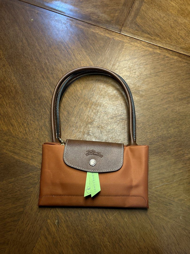 Longchamp Le Pliage Brique (Category: Tote Bags) located in Quezon City. Submitted by luxurybyluci (Listing ID 1458501571, Image 1). Description: Longchamp Le Pliage Brique Medium 7,000 with sling with inclusion authentic .