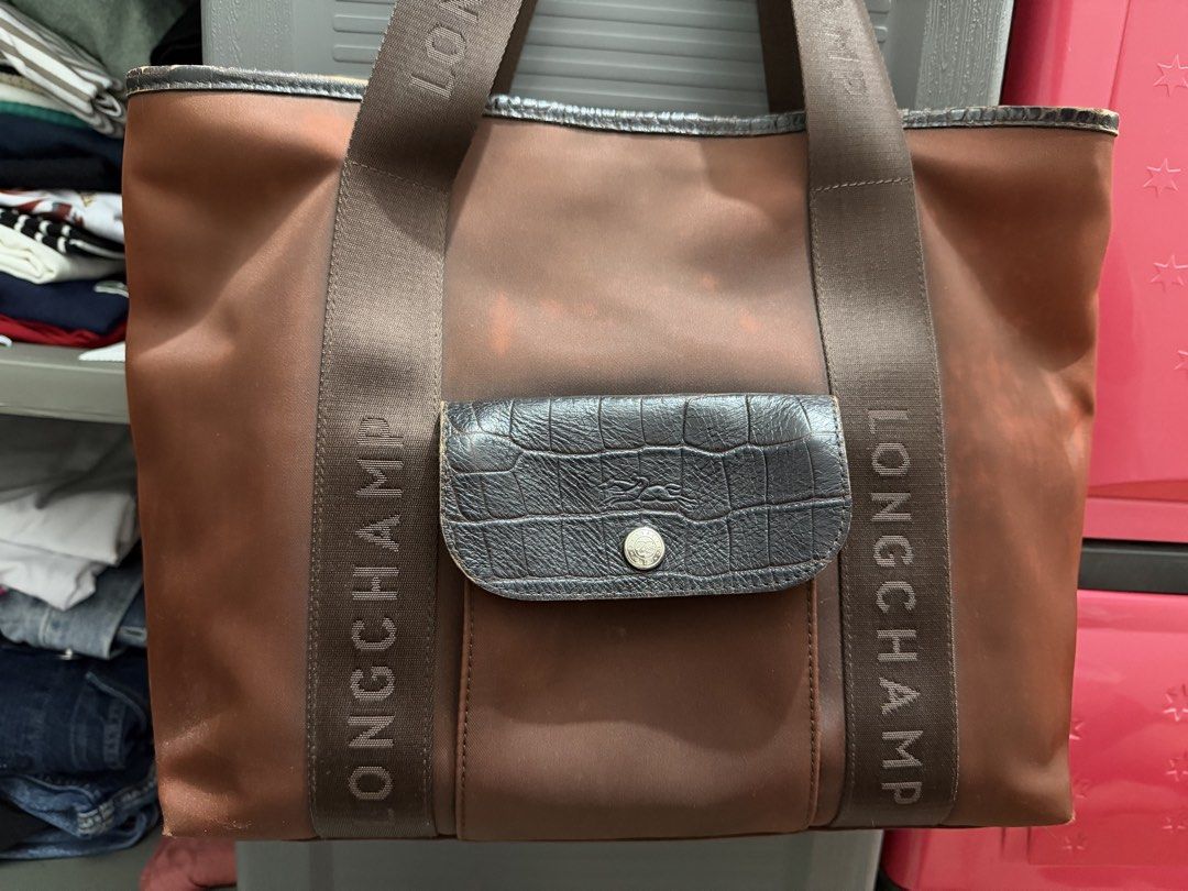 Longchamp Tote Bag Brown Crocodile Trim (Category: Luxury Bags & Wallets) located in Muntinlupa City. Submitted by thriftyfied (Listing ID 1458504393, Image 1). Description: - Authentic brown Longchamp tote bag - Elegant faux crocodile textured trim on pocket and handles - Embossed Longchamp logo on straps - Made in France - Interior zippered pocket for essentials - Used condition -with watermarks but can be cleaned - 100% auth -original price 4x