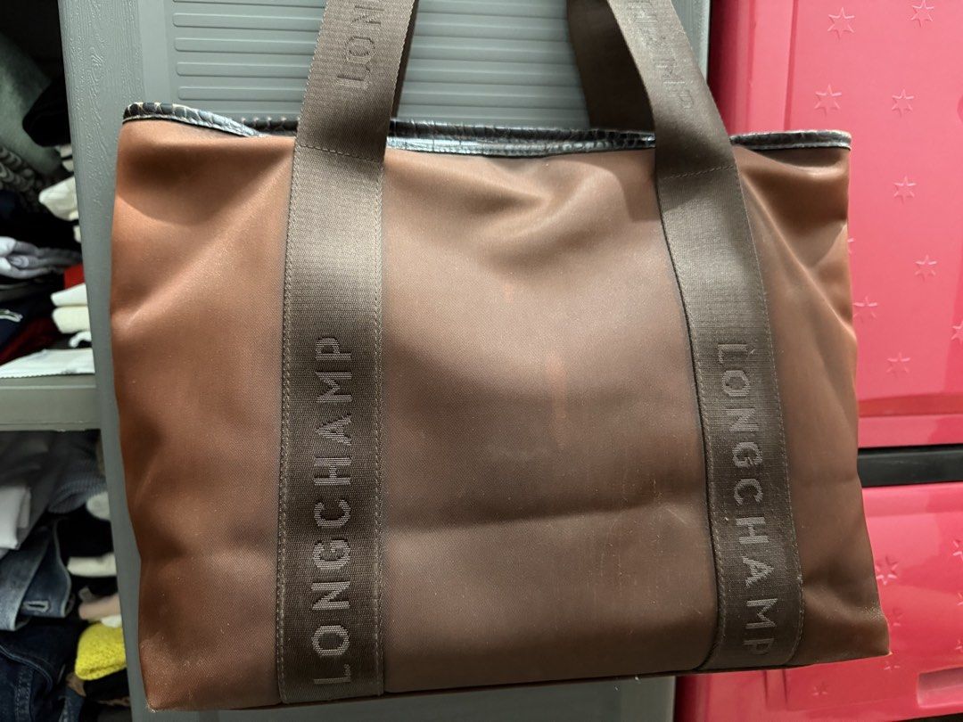 Longchamp Tote Bag Brown Crocodile Trim (Category: Luxury Bags & Wallets) located in Muntinlupa City. Submitted by thriftyfied (Listing ID 1458504393, Image 2). Description: - Authentic brown Longchamp tote bag - Elegant faux crocodile textured trim on pocket and handles - Embossed Longchamp logo on straps - Made in France - Interior zippered pocket for essentials - Used condition -with watermarks but can be cleaned - 100% auth -original price 4x